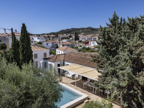 The pool house seen through the verdant foliage of the terraced grounds.